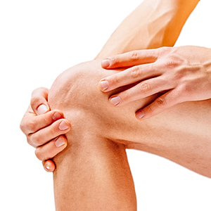 Photograph of flexed leg, with hand on the knee.